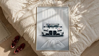 BMW M3 GT Race framed print styled on a bed with sneakers alongside