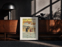 Black-framed woman and children wading at beach print on a moody console with designer coffee-table books
