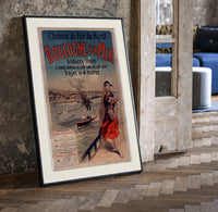 Woman in traditional dress by seaside print in a black frame leaning beside a vintage door on parquet