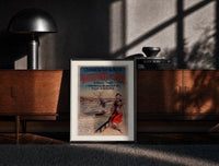 Black-framed woman in traditional dress by seaside print on a moody console with designer coffee-table books