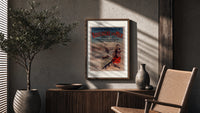 Woman in traditional dress by seaside poster framed above a fluted sideboard beside an olive tree