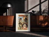 Black-framed Breton bagpiper and young woman print on a moody console with designer coffee-table books