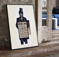 Monkey in top hat and suit print in a black frame leaning beside a vintage door on parquet