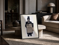 Monkey in top hat and suit print in a black frame leaning on a travertine table in a sunlit lounge