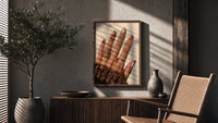 Brown Almond Nails poster framed above a fluted sideboard beside a potted tree