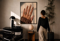 Brown Almond Nails print in a black frame on a sunlit wall with a viewer