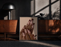 Black-framed Brown French Tips print on the floor in front of a dark wooden console