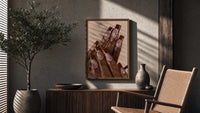 Brown French Tips poster framed above a fluted sideboard beside a potted tree