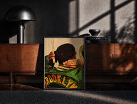 Black-framed Brushing Waves in a Varsity Jacket print on the floor in front of a dark wooden console