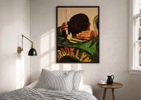 Brushing Waves in a Varsity Jacket print in a black frame above a bed with striped linens