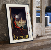 Man in red cloak holding lantern print in a black frame leaning beside a vintage door on parquet