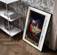 Man in red cloak holding lantern poster in a black frame leaning beside a shelf in a raw-plaster loft