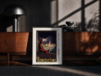 Black-framed Man in red cloak holding lantern print on a moody console with designer coffee-table books