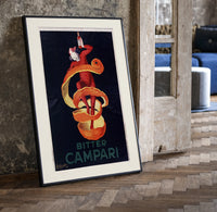 Clown wrapped in orange peel print in a black frame leaning beside a vintage door on parquet