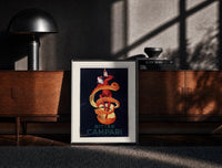 Black-framed Clown wrapped in orange peel print on a moody console with designer coffee-table books
