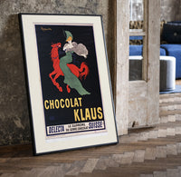 Woman in green riding red horse print in a black frame leaning beside a vintage door on parquet