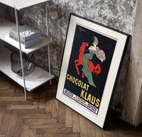 Woman in green riding red horse poster in a black frame leaning beside a shelf in a raw-plaster loft