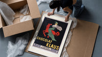 Woman in green riding red horse framed print being unpacked from protective bubble wrap and a box
