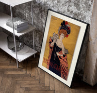 Elegant woman in evening gown poster in a black frame leaning beside a shelf in a raw-plaster loft