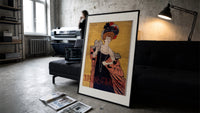 Elegant woman in evening gown print in a slim black frame leaning on a dark sofa in a concrete print studio