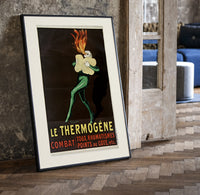 Fire-breathing man clutching cotton wool print in a black frame leaning beside a vintage door on parquet