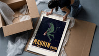 Green devil holding aperitif bottle framed print being unpacked from protective bubble wrap and a box