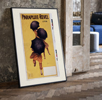 People walking with black umbrellas print in a black frame leaning beside a vintage door on parquet