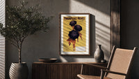 Cappiello Parapluie-Revel figures under black umbrellas poster framed above a fluted sideboard beside a potted tree
