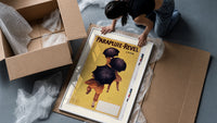 People walking with black umbrellas framed print being unpacked from protective bubble wrap and a box