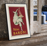 Pierrot serving plate of spaghetti print in a black frame leaning beside a vintage door on parquet