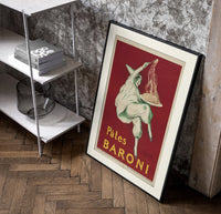 Pierrot serving plate of spaghetti poster in a black frame leaning beside a shelf in a raw-plaster loft