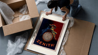 Two figures atop a pocket watch framed print being unpacked from protective bubble wrap and a box
