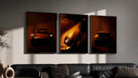 Porsche 911 Wall Art Set triptych in three black frames on a grey wall above a leather sofa