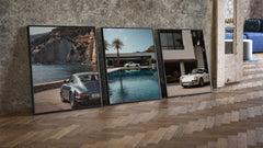 Porsche 911 Coastal Poster Set three-piece set leaning on parquet beside a vintage loft door