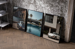 Porsche 911 Coastal Poster Set set of three black-framed prints leaning against a raw-plaster wall