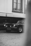 Vintage car parked on a street with a building in the background