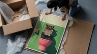 Cat on the Toilet Reading the Paper framed print being unpacked from protective bubble wrap and a box