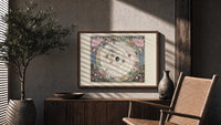 Antique celestial planisphere star chart print in a wood frame above a fluted sideboard beside an olive tree