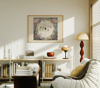Antique celestial planisphere star chart print in an oak frame above a mid-century book console with a vintage radio