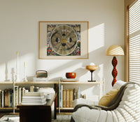 Copernican solar system celestial map print in an oak frame above a mid-century book console with a vintage radio
