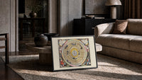 Ptolemaic celestial map of universe print in a slim black frame leaning on a travertine coffee table