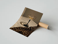 Gently curled Champagne Coupe with Leopard print beside its protective shipping tube