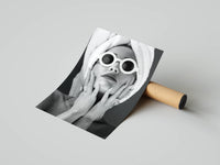 Rolled monochrome luxury fashion photography print showing round sunglasses in a studio mockup