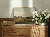 Peasant woman in harvest field print in an oak frame on a farmhouse dresser beside white tulips