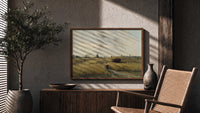Peasant woman in harvest field print in a wood frame above a fluted sideboard beside an olive tree