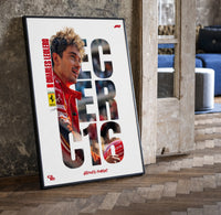 Charles Leclerc F1 driver portrait print in a black frame leaning beside a vintage door on parquet