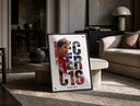 Charles Leclerc F1 driver portrait print in a black frame leaning on a travertine table in a sunlit lounge