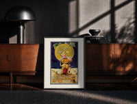 Black-framed Pumpkin-headed figure with harvest moon print on a moody console with designer coffee-table books