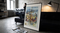 French spa town travel scenery print in a slim black frame leaning on a dark sofa in a concrete print studio
