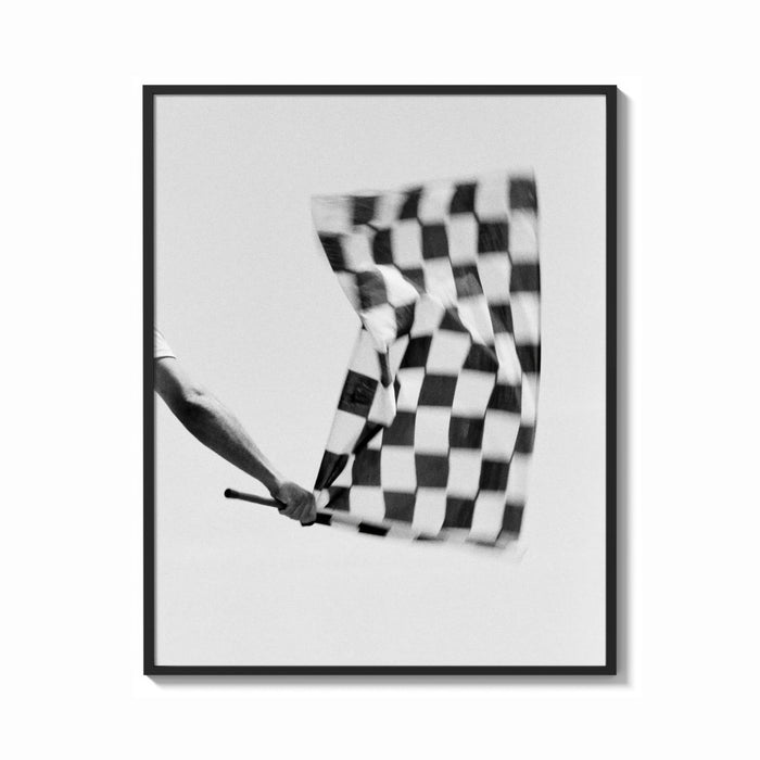 Framed Hand waving checkered racing flag print shown as a bold statement piece on a clean gallery wall